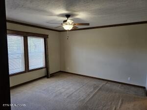 211 North Springview Road Maryville, TN 37801 - Photo 13 of 27 an empty room with a chandelier fan and windows