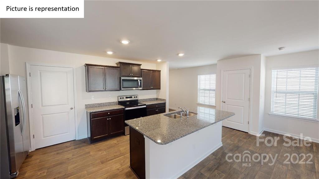 5038 Fandango Road York, SC 29745 - Photo 24 of 26 a kitchen view with stainless steel appliances granite countertop a sink stove and refrigerator