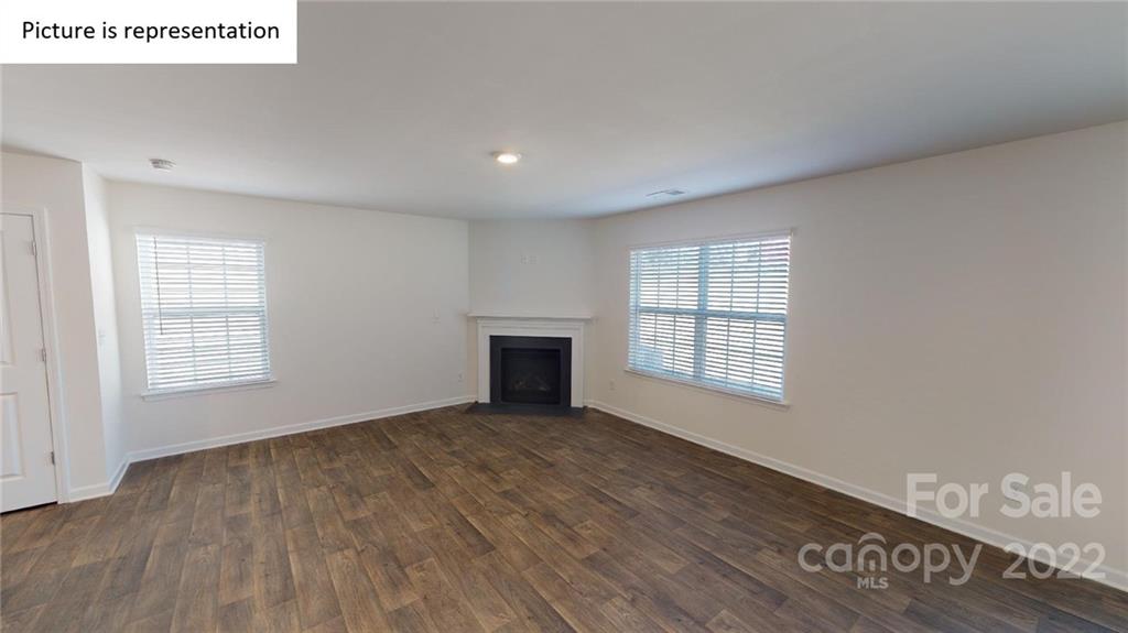 5038 Fandango Road York, SC 29745 - Photo 5 of 26 an empty room with wooden floor and windows