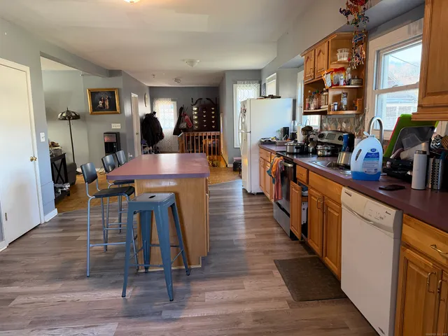 a large kitchen with lots of counter space and wooden floor