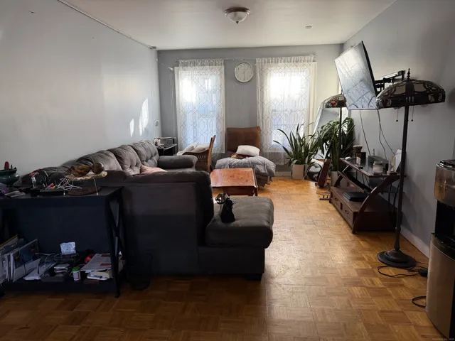 a living room with furniture gym equipment and view of living room