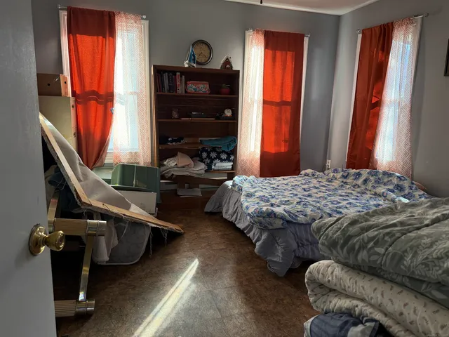 a bedroom with furniture and a window