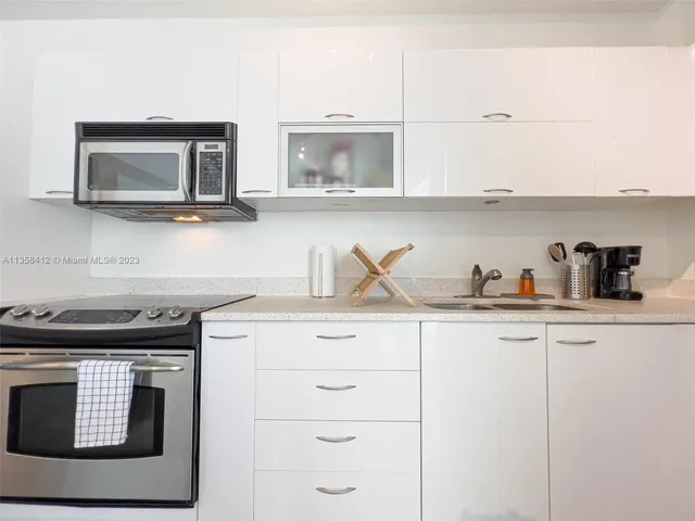 a kitchen with cabinets and stainless steel appliances