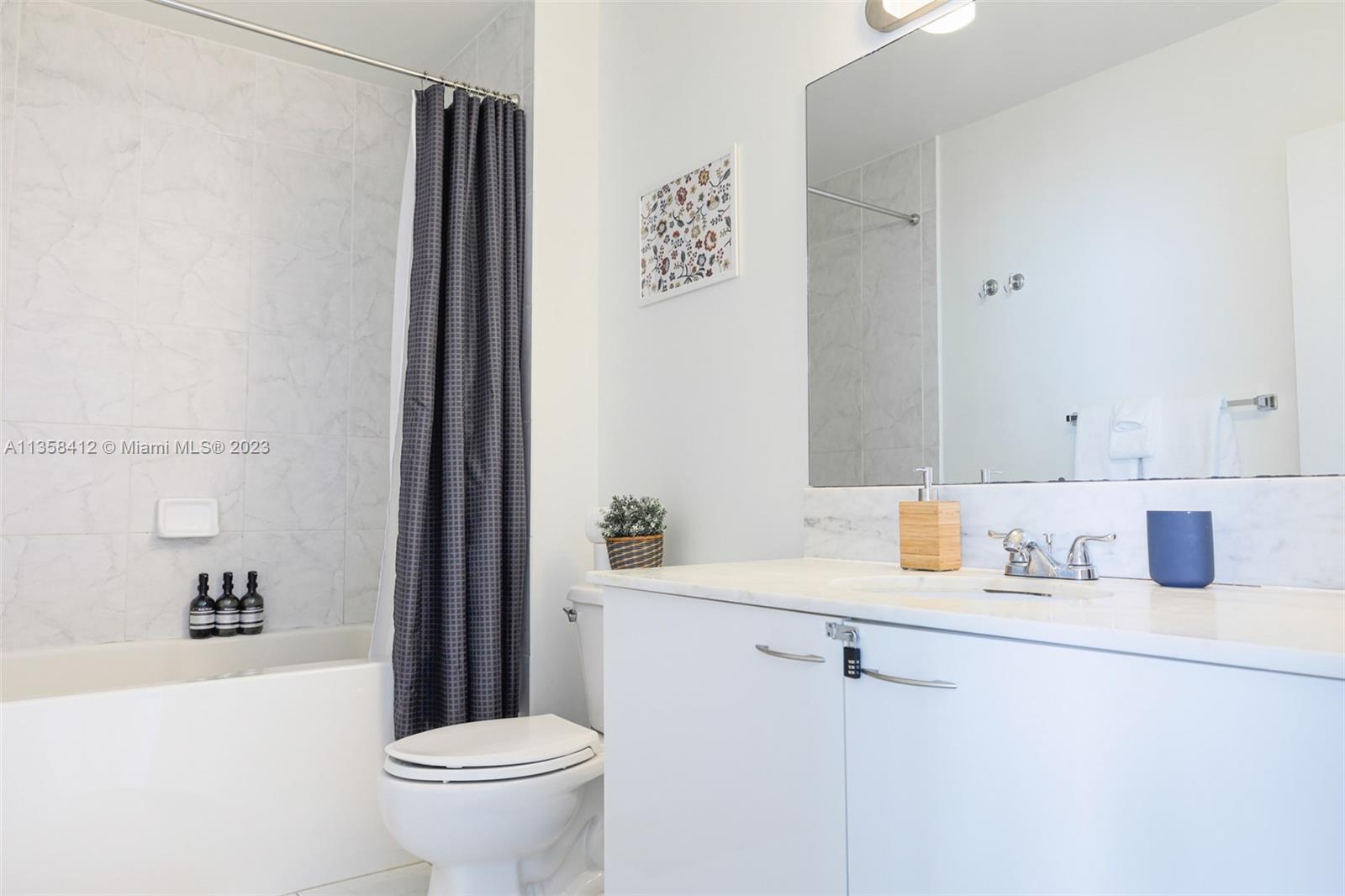 133 Northeast 2nd Avenue, Unit 1410 Miami, FL 33132 - Photo 18 of 25 a bathroom with a sink toilet and shower