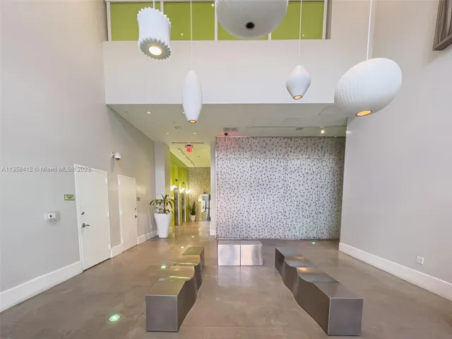 a living room with a couch and potted plant