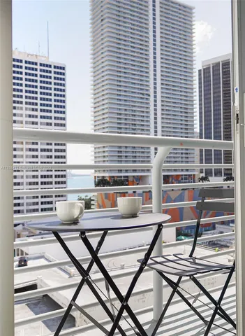 a view of a balcony with table and chairs
