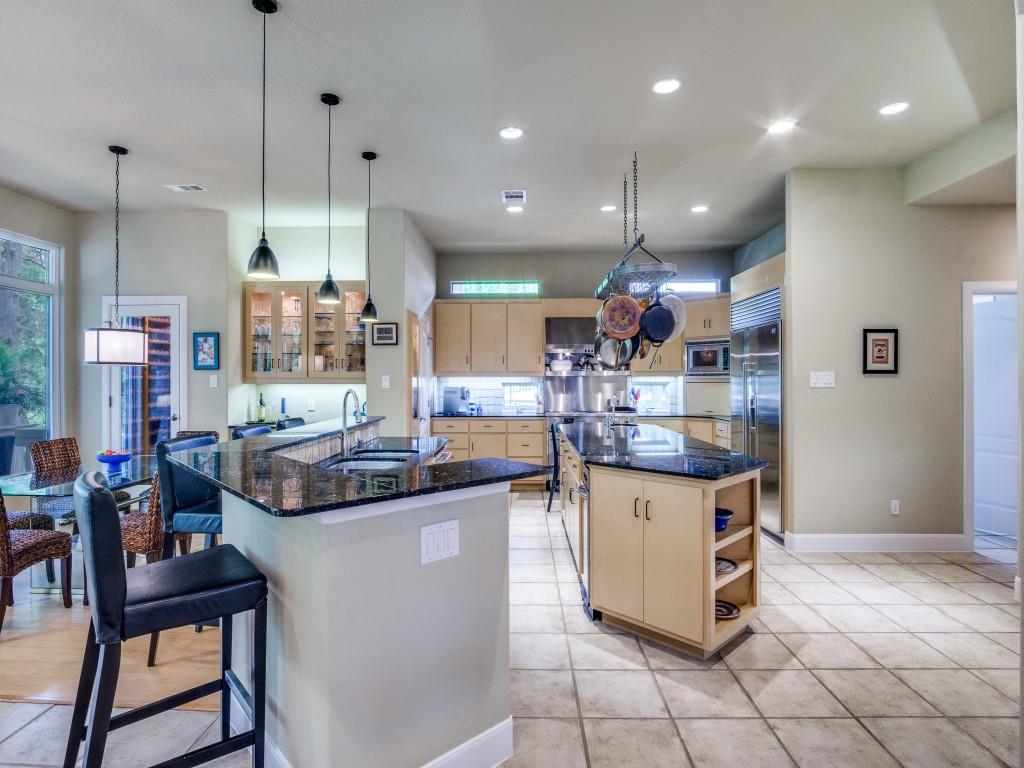 1014 Amanda Drive Mansfield, TX 76063 - Photo 11 of 40 a kitchen with stainless steel appliances granite countertop a sink a stove and a wooden cabinets