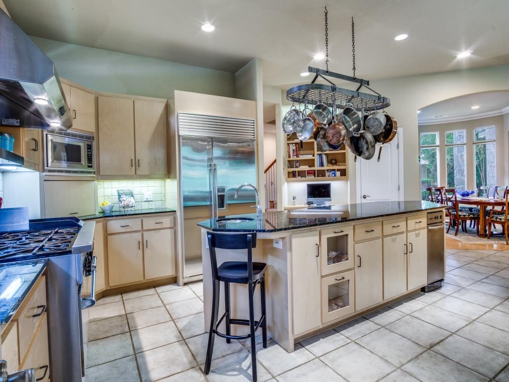 1014 Amanda Drive Mansfield, TX 76063 - Photo 12 of 40 a kitchen with stainless steel appliances granite countertop a stove a sink and a microwave