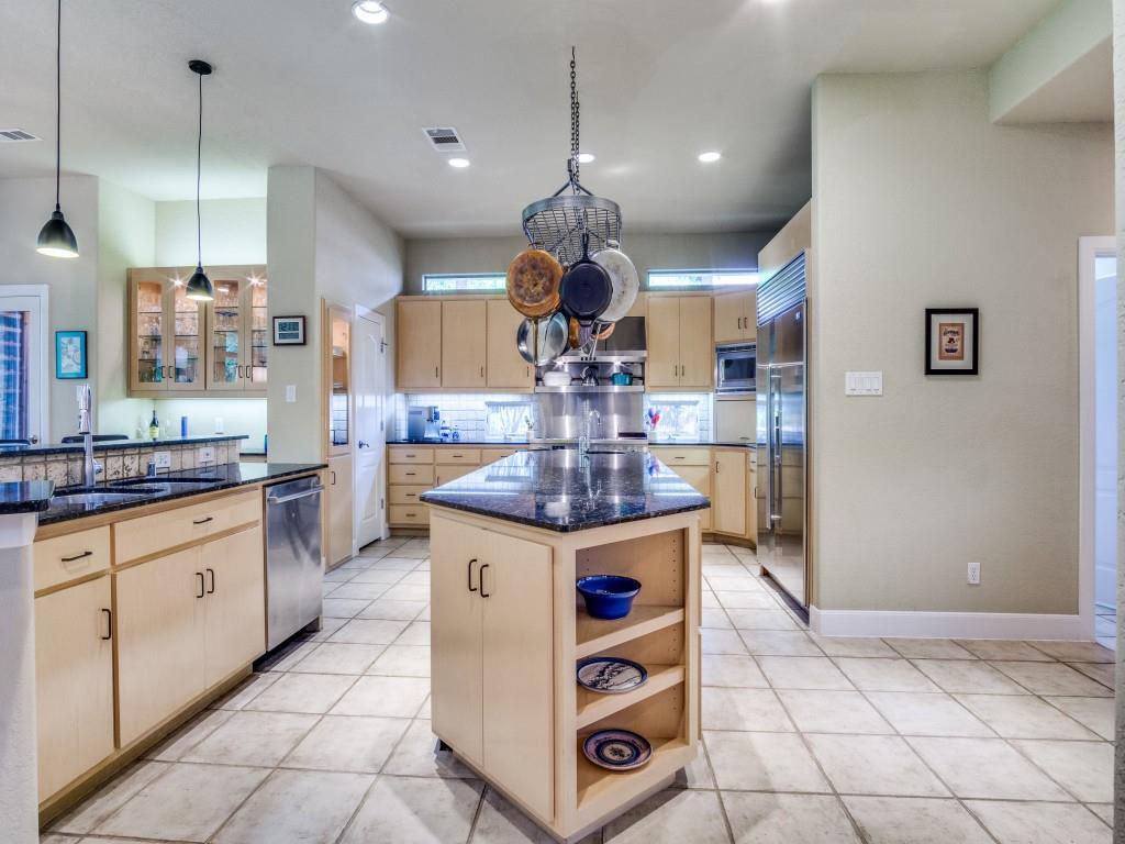 1014 Amanda Drive Mansfield, TX 76063 - Photo 15 of 40 a kitchen with kitchen island granite countertop a stove a sink a counter top space and cabinets