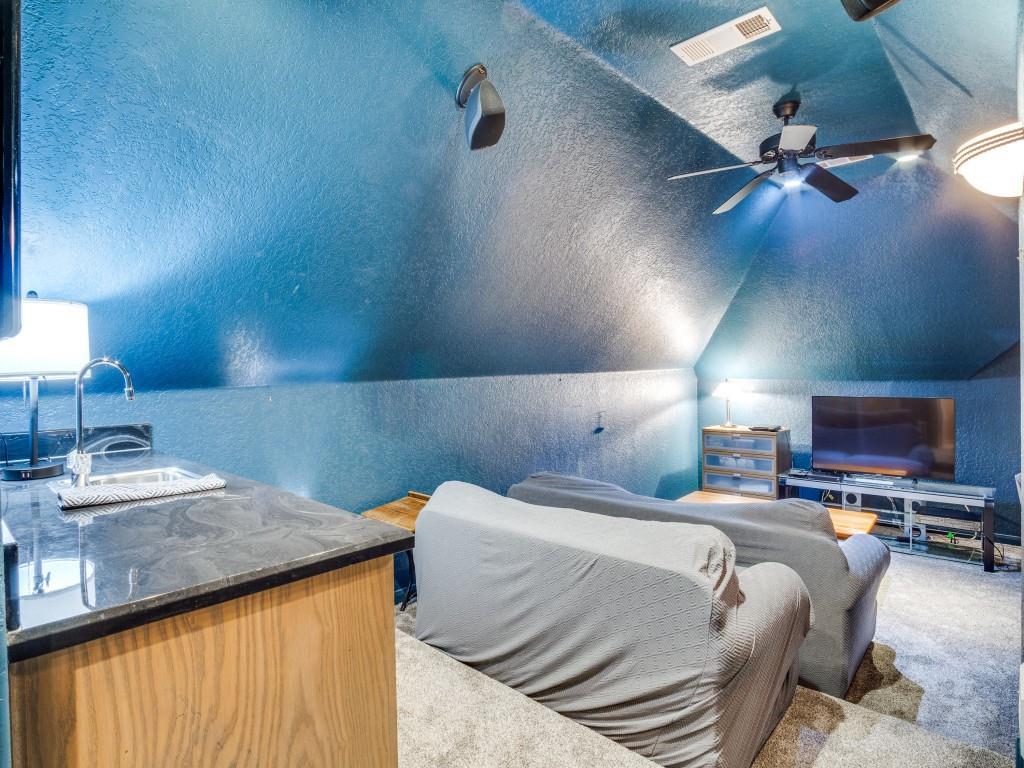 1014 Amanda Drive Mansfield, TX 76063 - Photo 31 of 40 a bedroom with a bed and a chandelier