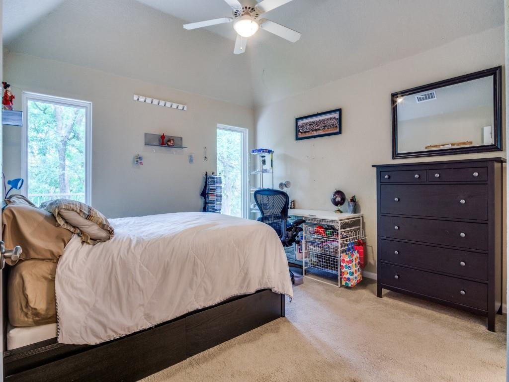 1014 Amanda Drive Mansfield, TX 76063 - Photo 34 of 40 a bedroom with a bed and a flat tv screen on dresser