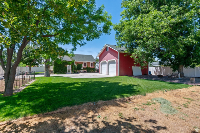 1214 North 300 West Mapleton, UT 84664 - Photo 32 of 33 Expansive green lawn with mature trees and a detached two-car garage