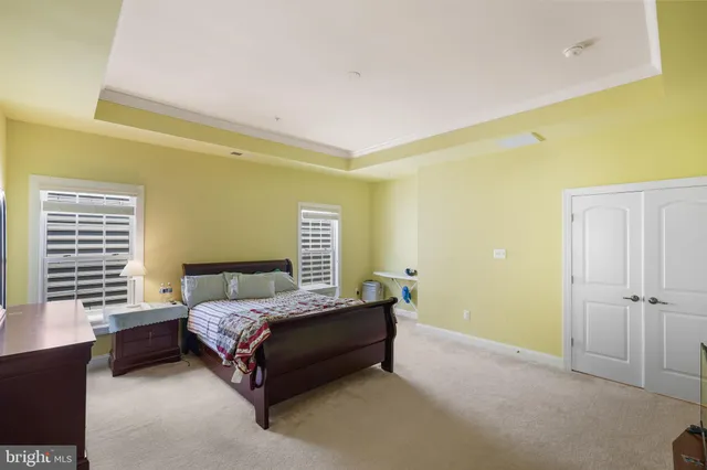 a bedroom with a bed and a potted plant