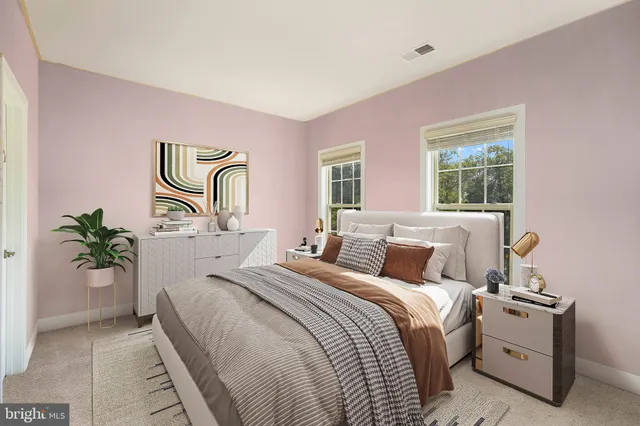 a bedroom with a bed and a painting on the wall