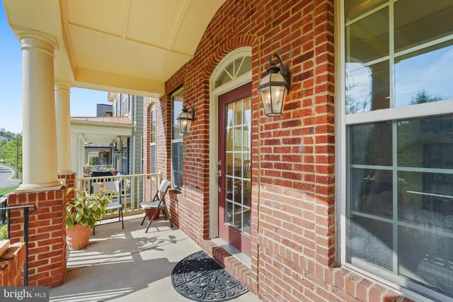 a view of a door with a chair and a potted plant