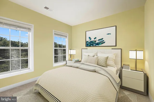 a bedroom with bed and a painting on the wall