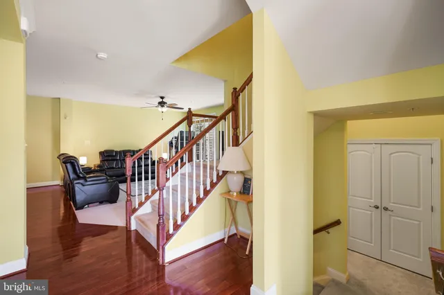 a view of a hallway with wooden floor and glass door