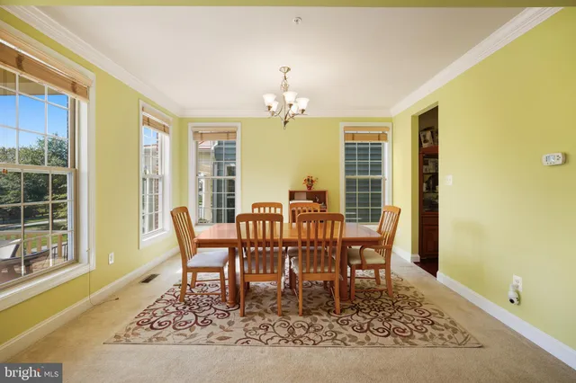 a dining room with furniture a rug and wooden floor