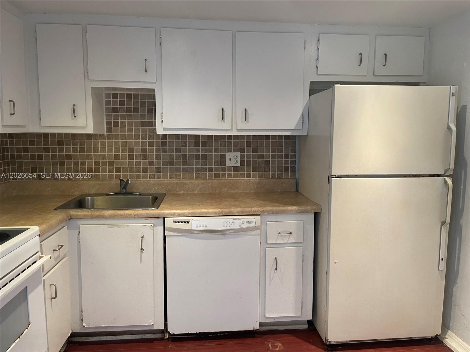 4174 Inverrary Drive, Unit 903 Lauderhill, FL 33319 - Photo 15 of 36 a kitchen with a refrigerator sink and cabinets