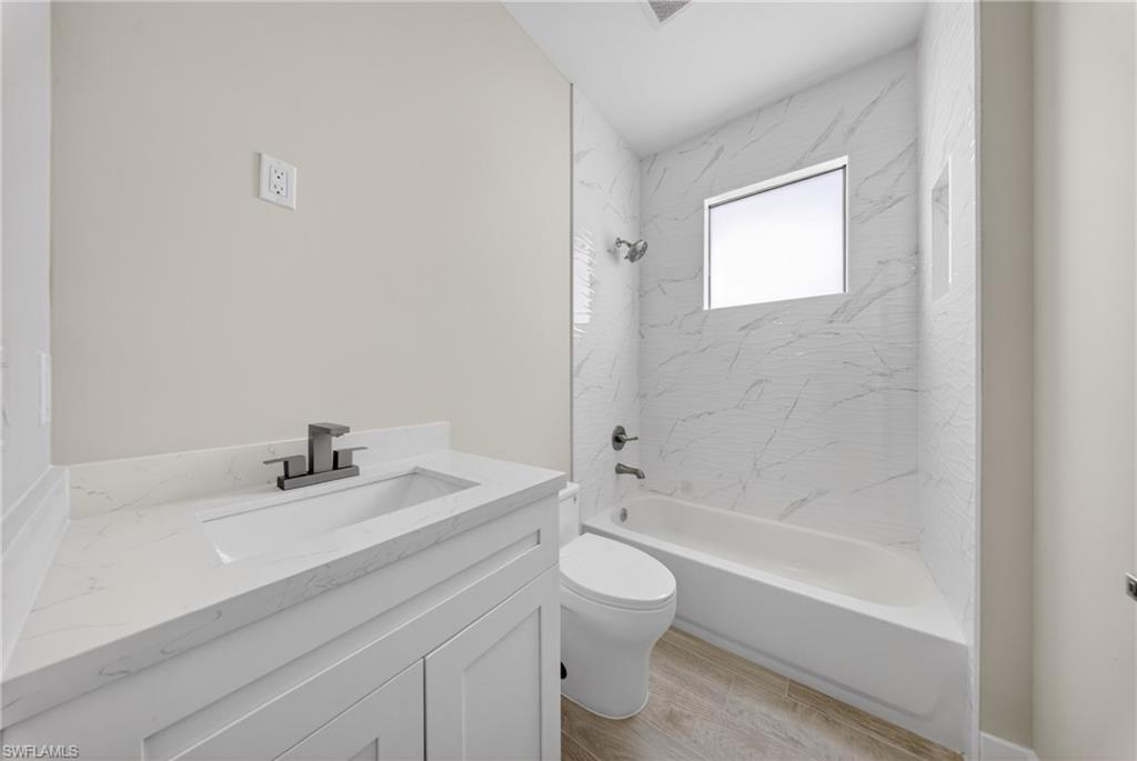 18 Scott Avenue Lehigh Acres, FL 33936 - Photo 22 of 37 a bathroom with a sink a toilet and shower