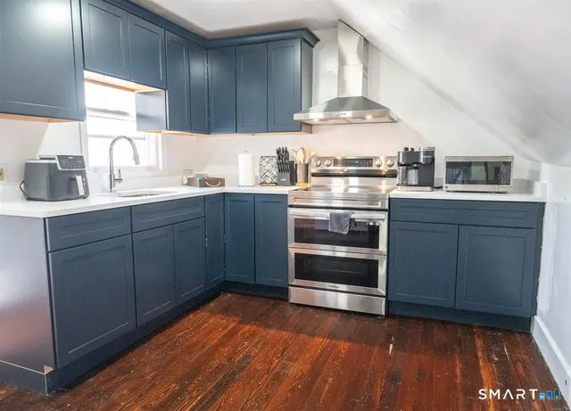 a kitchen with stainless steel appliances a stove and a sink
