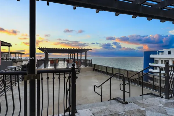 a view of a patio with a table and chairs