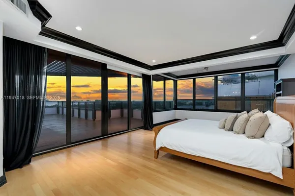 a living room with furniture a flat screen tv and kitchen view
