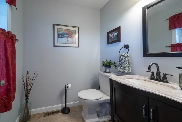 a bathroom with a toilet a sink and mirror