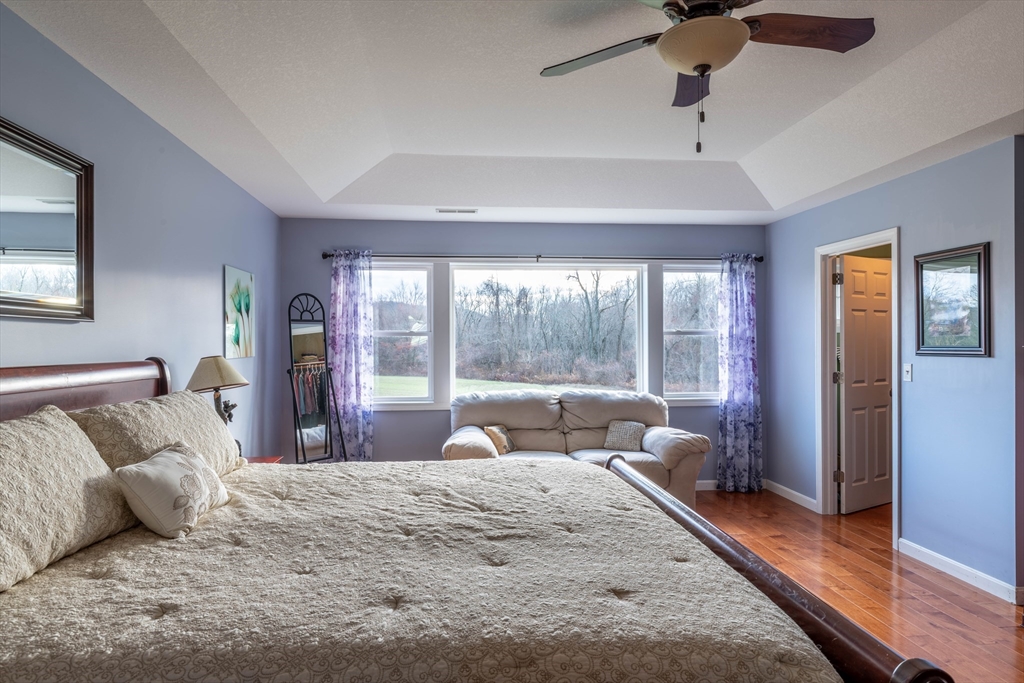 83 Bay Road Hadley, MA 01035 - Photo 16 of 36 a bedroom with a bed and glass walk in closet