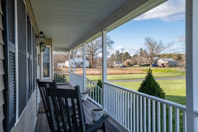 a view of a balcony with lake view and wooden floor