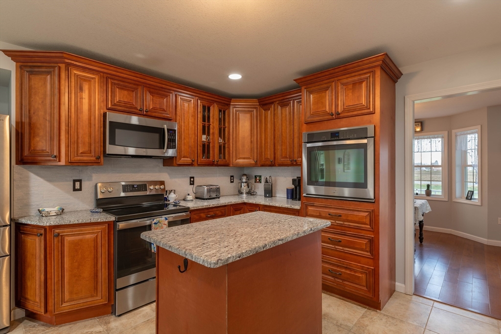 83 Bay Road Hadley, MA 01035 - Photo 8 of 36 a kitchen with stainless steel appliances granite countertop wooden cabinets a stove top oven a sink and dishwasher