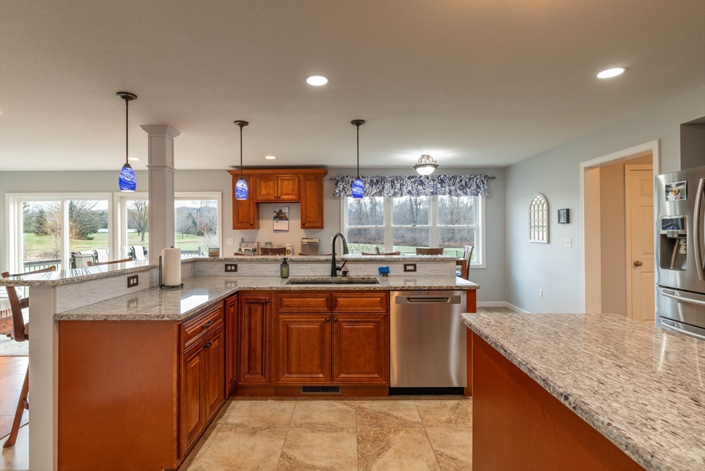 83 Bay Road Hadley, MA 01035 - Photo 9 of 36 a kitchen with stainless steel appliances granite countertop a sink a stove and a refrigerator