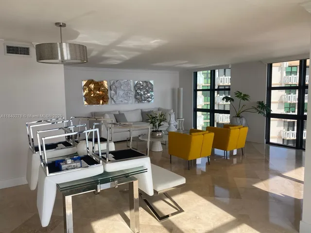 a living room with furniture and a book shelf