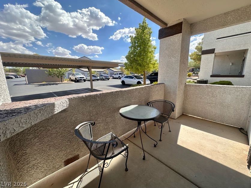 7255 West Sunset Road, Unit 1027 Las Vegas, NV 89113 - Photo 24 of 25 An inviting outdoor patio offers a comfortable spot for relaxation with a view of the convenient carport.