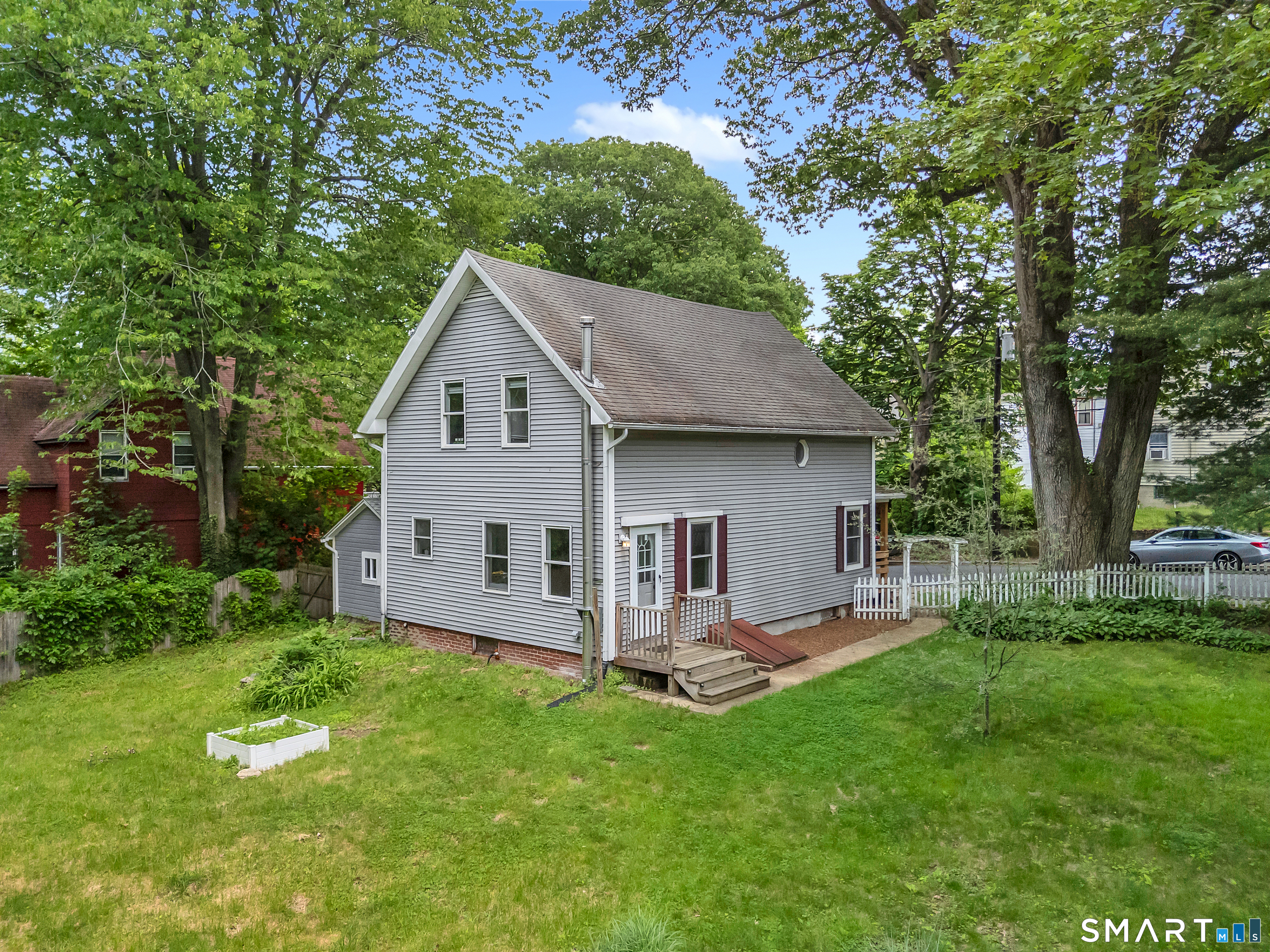 75 Summit Street Norwich, CT 06360 - Photo 3 of 40 a view of a house with a backyard and a patio