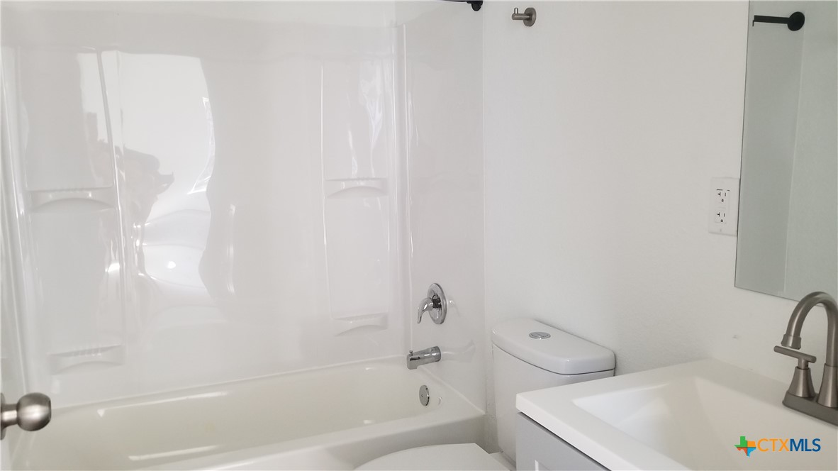 1063 Sleepy Hollow Lane Spring Branch, TX 78070 - Photo 11 of 14 a white bath tub sitting next to a white toilet