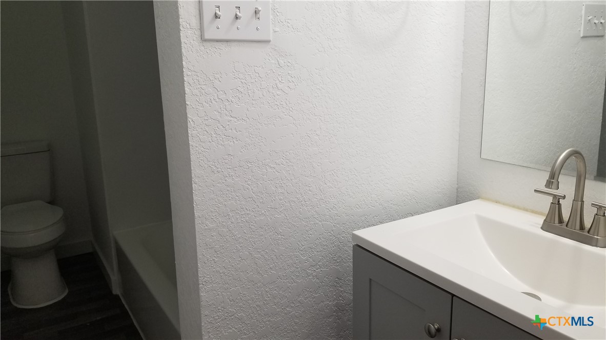 1063 Sleepy Hollow Lane Spring Branch, TX 78070 - Photo 13 of 14 a bathroom with a sink and a toilet