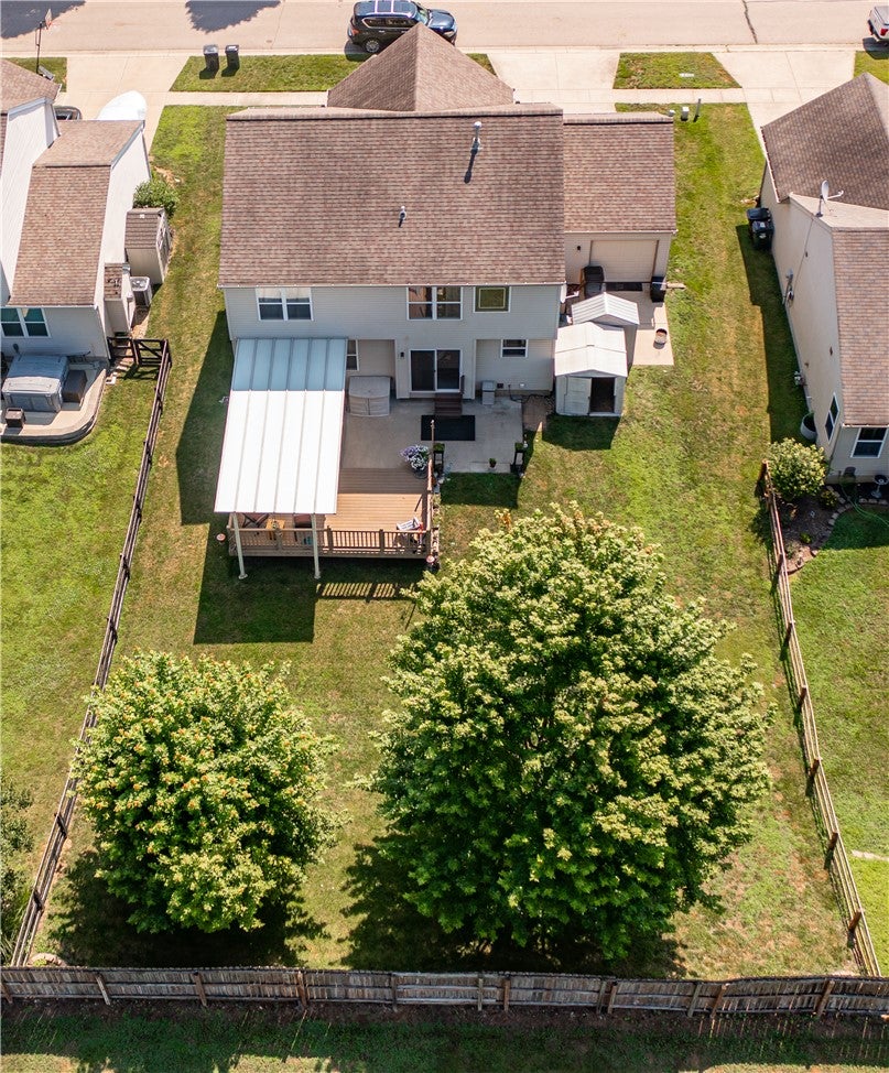 10765 Stone Ridge Way Harrison, OH 45030 - Photo 64 of 68 An aerial perspective reveals a charming backyard complete with a covered deck and mature trees, all enclosed by a private fence.