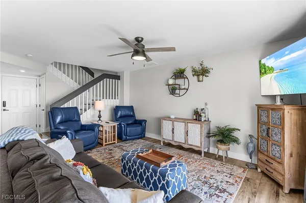 a living room with furniture and wooden floor