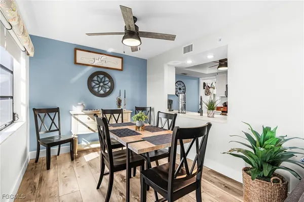a view of a dining room with furniture and a chandelier