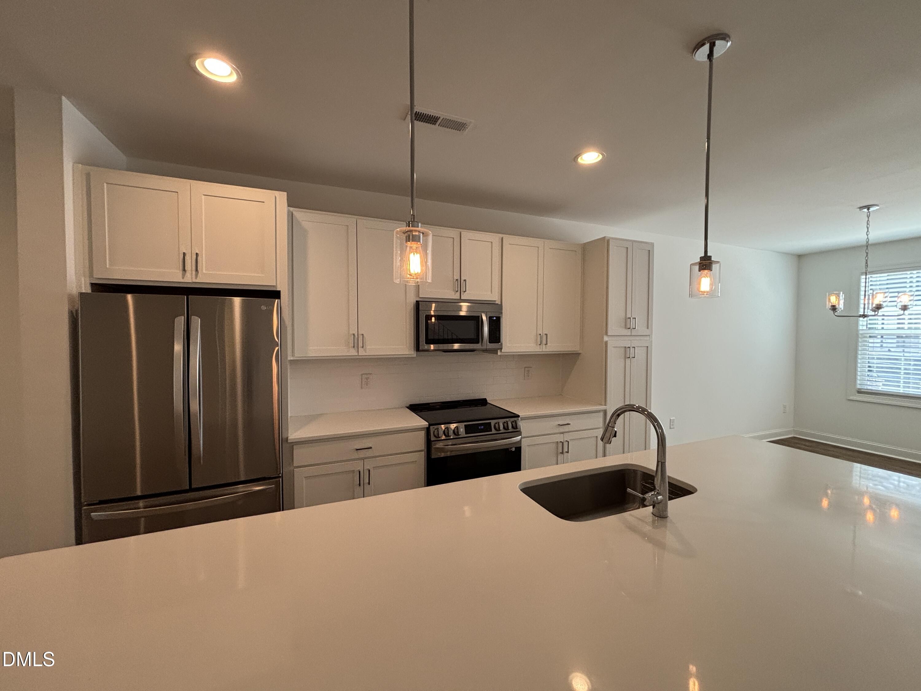 5710 Parker Pnes Court Raleigh, NC 27609 - Photo 36 of 78 a kitchen with stainless steel appliances granite countertop a refrigerator a sink and a stove
