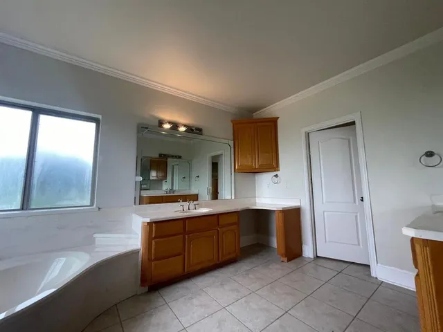 a kitchen with cabinets and stainless steel appliances