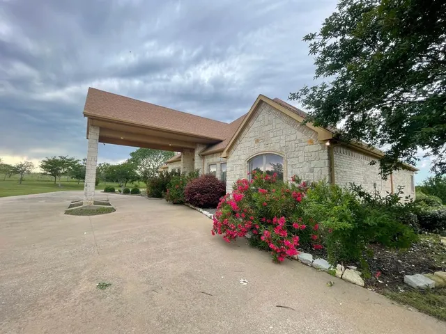 a view of a house with a backyard and garden