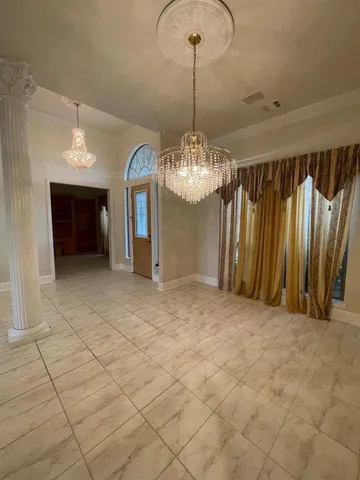 an empty room with fireplace and windows