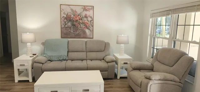 a living room with a flat screen tv and a window