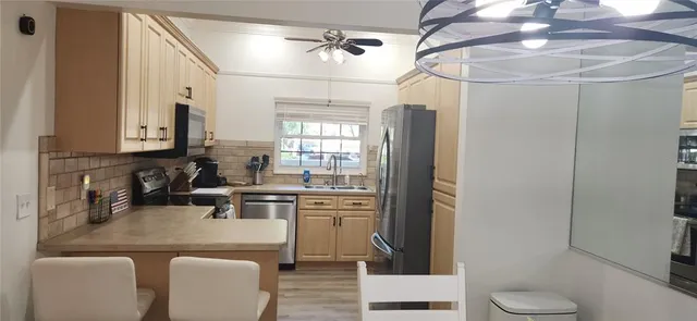 a bedroom with a bed and a flat tv screen on dresser