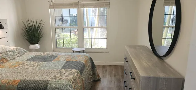 a bedroom with furniture and a window