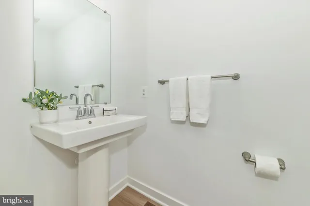 a bathroom with a sink a mirror and a shower