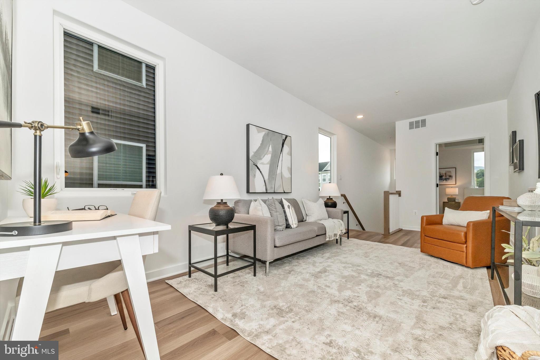 720 Iron Frg Road Frederick, MD 21702 - Photo 15 of 33 a living room with furniture and a wooden floor