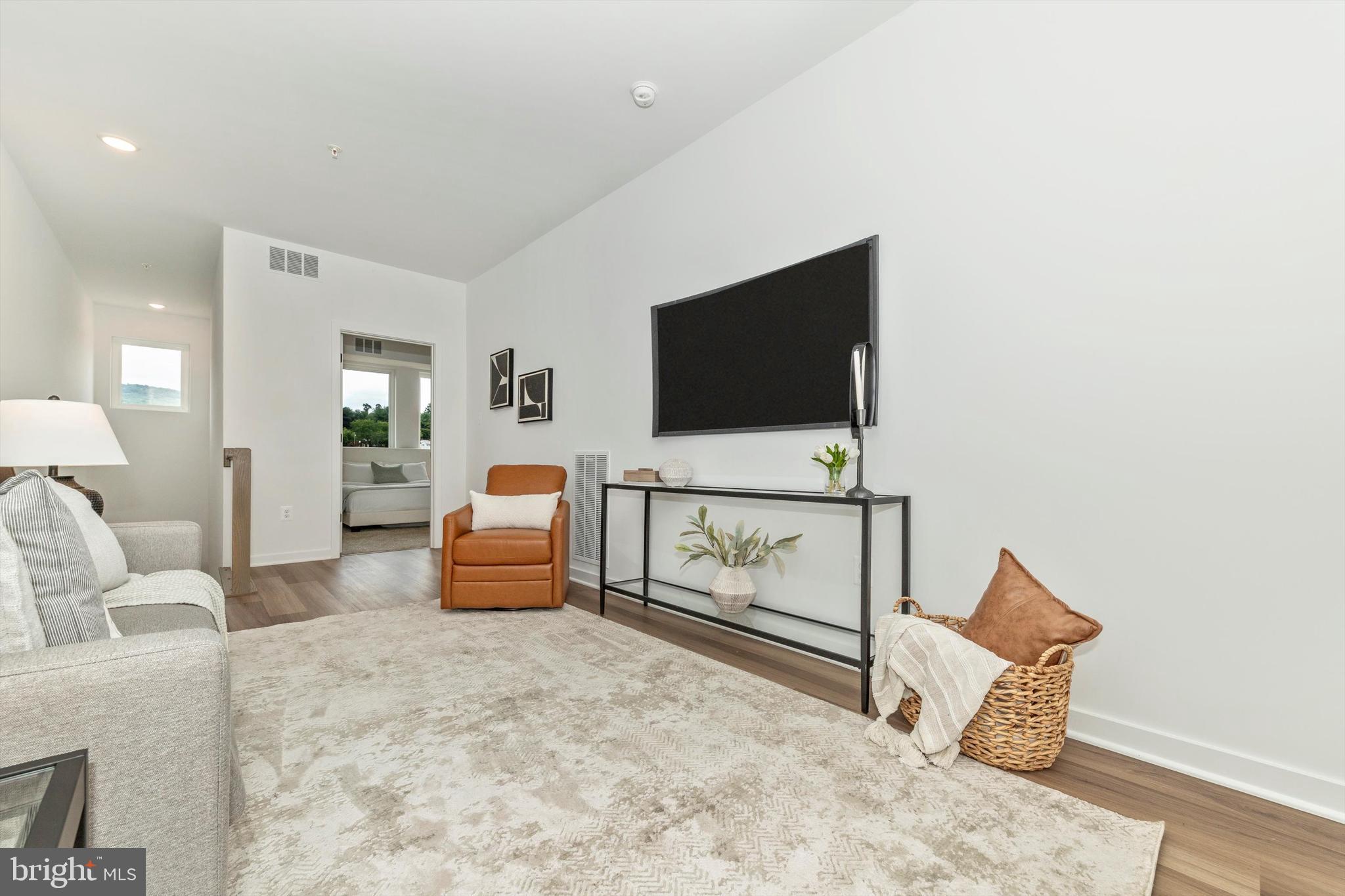 720 Iron Frg Road Frederick, MD 21702 - Photo 18 of 33 a living room with furniture and a flat screen tv